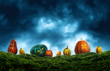 Cute and evil colorful halloween pumpkins on grass