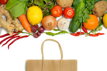 Fresh vegetables, fruits, herbs, and spices spilling from a reusable paper bag. Zero waste, no plastic, eco-friendly grocery shopping concept on white background.