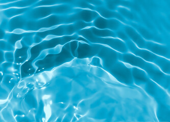 Abstract blurred shades of blue water background. Light and shadow ripples or splashes surface of water texture. Water waves with shining and reflection pattern photography for​ design artwork.