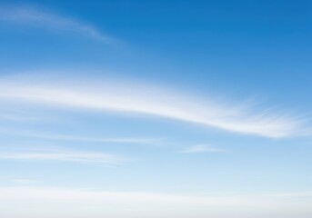 Obraz premium Vast expanse of a clear blue sky with delicate wispy white clouds stretching across the horizon on a bright sunny day