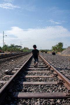 a boy on railway tracks