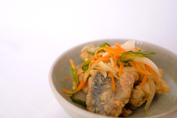 Nanbanzuke , Fried horse mackerel marinated in sweet and spicy vinegar. 
