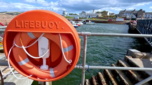 Lifebuoy Ring on Cromarty Pier Overlooking Seaside Town