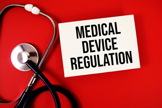 MDR Medical Device Regulation text written on paper card with stethoscope on red background