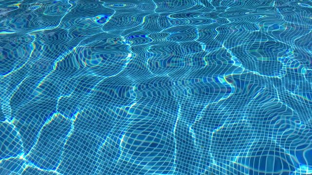 The water in the pool is blue, permeated with glitter and shimmer in the sun. Healthy lifestyle. Recreation for children.