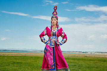 Mongolian girls dressed in luxurious Mongolian costumes on the grassland