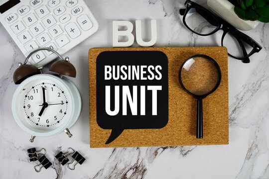 BU - Business Unit acronym with calculator, alarm clock and magnifying glass, Business concept background