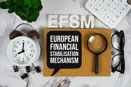 EFSM - European Financial Stabilisation Mechanism acronym with calculator, alarm clock and magnifying glass, Business and Financial concept background - Powered by Adobe