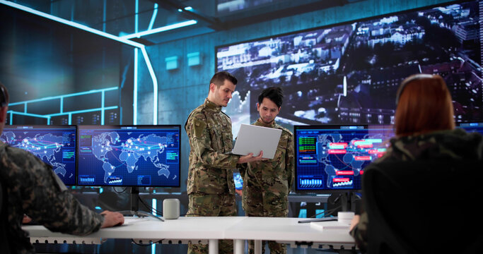 Military Team Of Soldiers Monitor Intelligence In Control Center Together