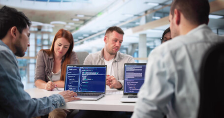 Naklejka premium Multiracial Software Engineers Collaborate On Coding Project