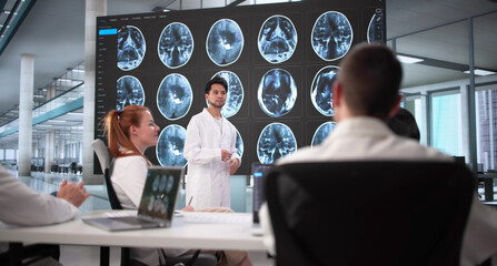 Diverse Medical Team Analyzing MRI Imaging During Group Meeting
