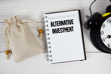 Alternative Investment text with money bag and alarm clock on wooden background
