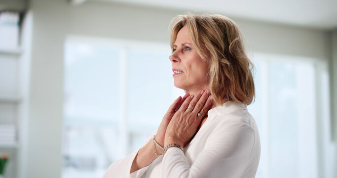 Senior Woman Touching Her Swollen Tonsil Glands