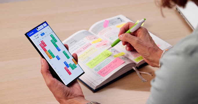 The Elderly Lady Holding A Smartphone Organizing Her Business