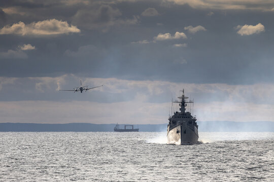 A military plane flies over a warship during a peacekeeping operation in the Black Sea.	