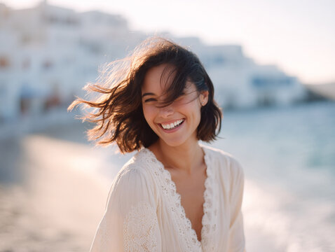 Radiant woman laughing freely at the beach. Evokes joy, natural beauty, and carefree travel. Ideal for lifestyle, wellness, or vacation ads.