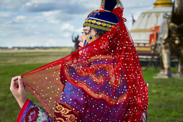 Mongolian girls dressed in luxurious Mongolian costumes on the Mongolian war chariots of the Jinyuan Grand Tent on the grassland