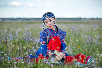 Mongolian girls dressed in luxurious Mongolian costumes on the grassland