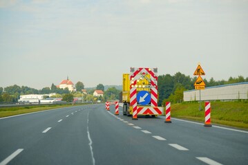 Highway Roadwork Zone with Warning Signs and Safety Barriers