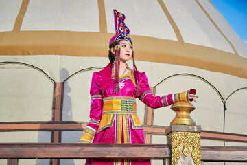 Mongolian girls dressed in luxurious Mongolian costumes on the Mongolian war chariots of the Jinyuan Grand Tent on the grassland