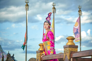 Mongolian girls dressed in luxurious Mongolian costumes on the Mongolian war chariots of the...