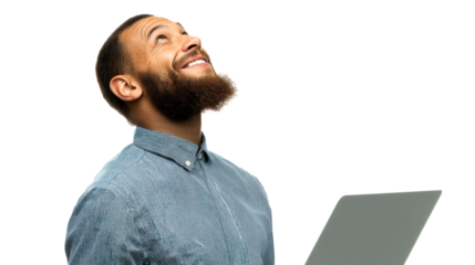 Black man with beard looks up smiling while holding a laptop