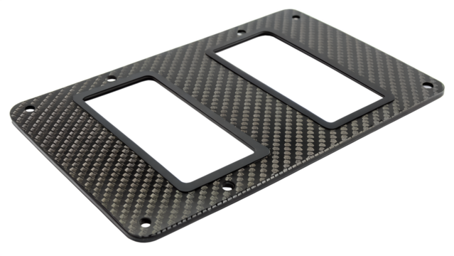 Carbon fiber plate with two rectangular openings and a textured weave pattern, isolated on a transparent background