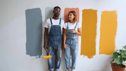 Video happy couple front of wall with selective wall painting, people laughing and discussing paint choice for wall, work connecting everyday life with fun, handheld shooting zoom in camera shaking - Powered by Adobe