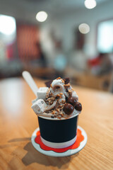 frozen yogurt in cup with chocolate nuts marshmallows toppings, stylish deliciousness and sweet indulgence, creamy soft serve dessert with gourmet toppings