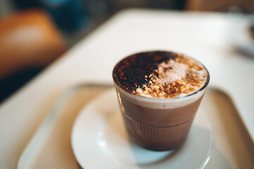 cocoa cup with nuts coconut flakes in cafe, warm indulgence and cozy delight, chocolate beverage topped with chopped nuts shredded coconut in coffee shop