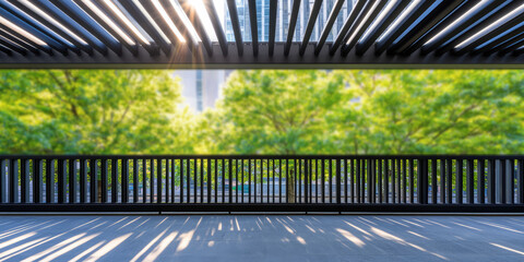 A row of trees is seen through a slatted structure casting shadows on the ground, with sunlight filtering through. Urban greenery and architectural design