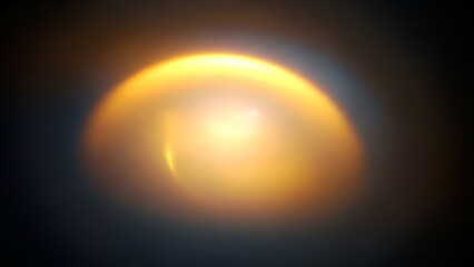 Obraz premium Golden orb abstract light effect against dark background showcasing luminous glow