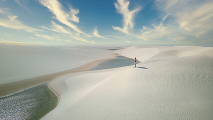 Photo of the Lencois Maranhenses landscape with a man in the middle
