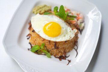 biriyani with egg omelet on top image