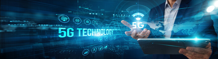 An engineer using a tablet analyzes 5G technology network data connectivity, latency optimization automation monitoring innovation integration scalability performance.