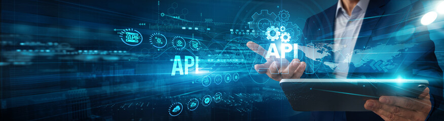 Developer using a tablet analyzing API integration data connectivity, automation monitoring scalability innovation optimization, and interoperability solutions development.