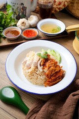 Mixed Chicken and rice ,boied chicken with fried chicken and rice,coriander and cucumber with sauce and soup , hainanese chicken rice, thai called khao man gai,
