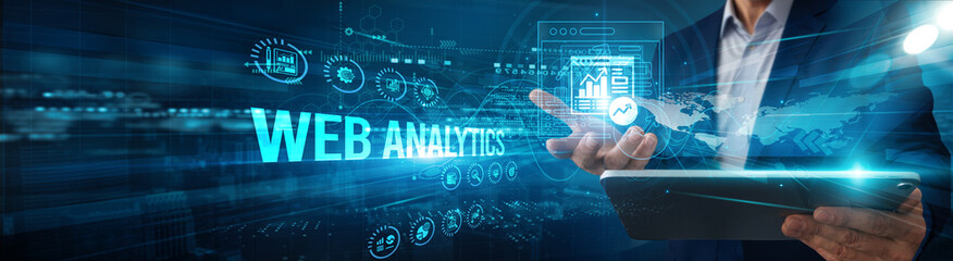 Marketer using a tablet analyzing web analytics traffic data performance, monitoring engagement...