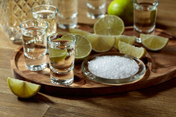 Gold tequila with salt and lime slices.