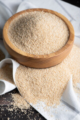Raw organic amaranth grain. Amaranth seeds in a bowl on wooden table.	