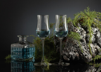 Blue gin on a black reflective background.