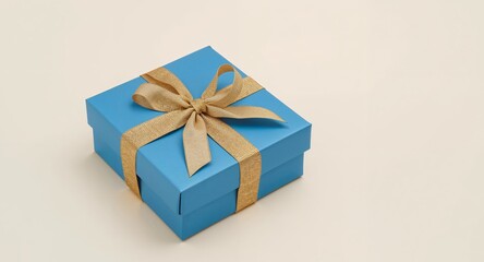 Obraz premium Blue Gift Box with Golden Ribbon, Perfect for Birthdays, Anniversaries, or Special Occasions.