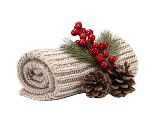 Rolled beige knitted scarf with pinecones, red berries and pine branch on white background