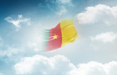 Cameroon flag waving light background hidden in the sky.