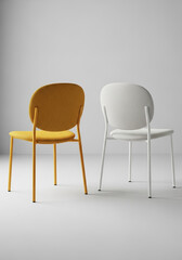 Two modern chairs one orange and one white against a light gray background