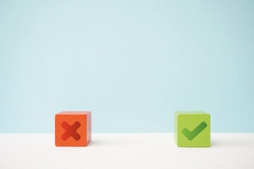 Red and green wooden blocks showing incorrect and correct concepts on light blue and white background