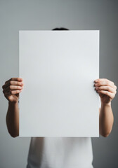 Person holding a blank white square sign for your message