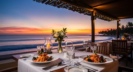 Wandcirkels Foto's Romantic dinner setting on a beach at sunset, with pasta dishes and ocean view.  © Ayase
