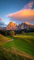 Sunlit mountain peaks at sunset over rolling green hills and a winding road