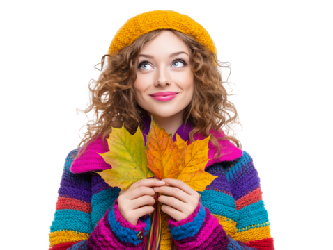 Young woman in colorful sweater holding autumn leaves and smiling